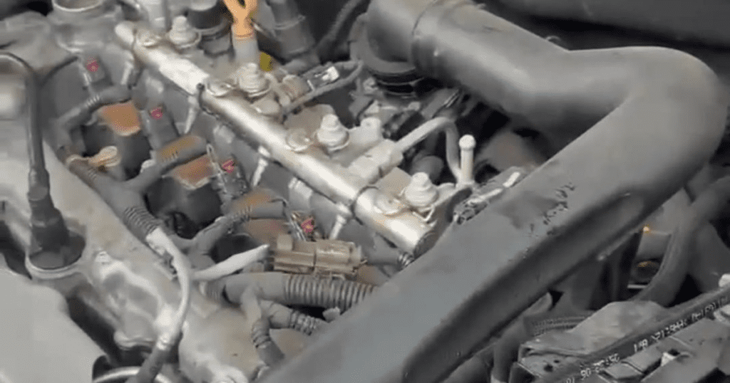 A close-up view of an internal engine block showing cylinder head components, valves, and mechanical parts in detail.